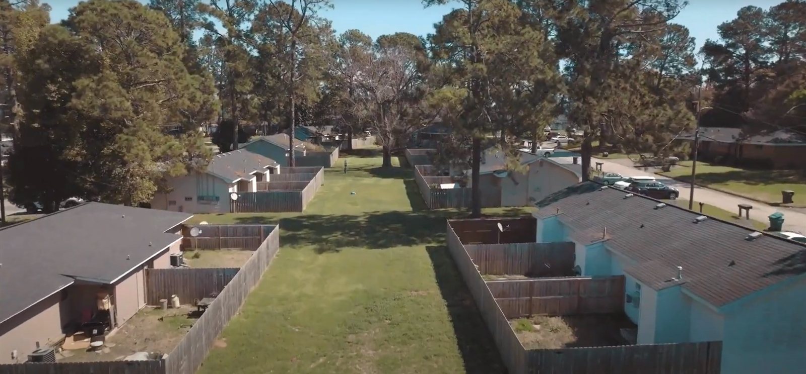 Aerial view of The Mill Gardens Apartments — a quiet, low-rise, garden-style pet-friendly community in Bonaire, GA with mature trees and grassy common areas
