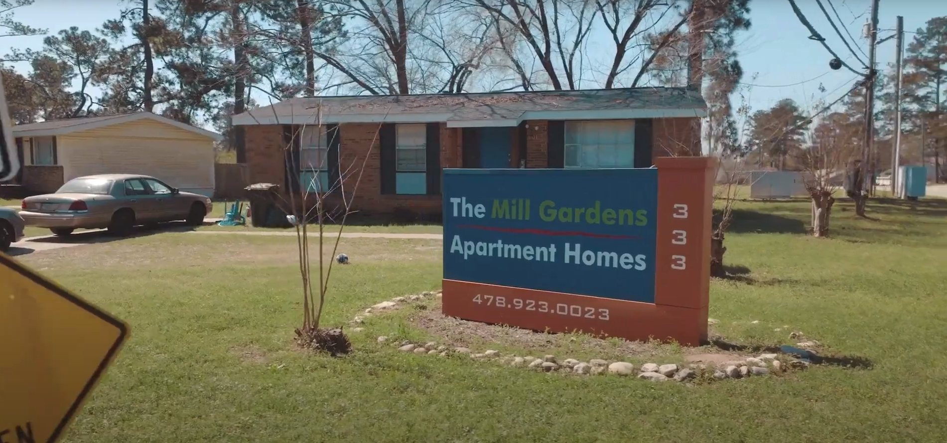 The Mill Gardens Apartments sign