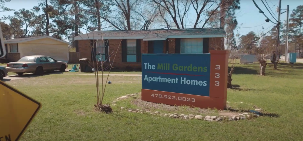 the mill gardens apartments sign